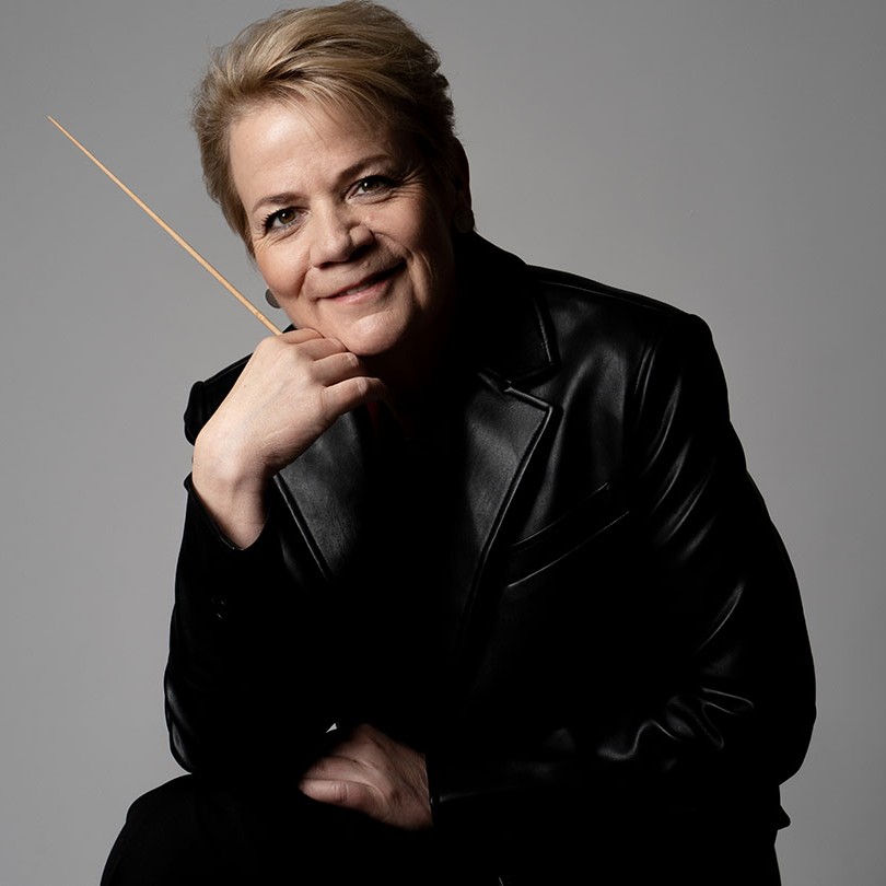 Conductor Marin Alsop smiling with baton